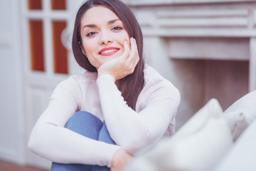 High spirits. Portrait of gorgeous attractive charismatic woman propping her chin on hand while...