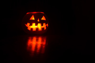 Halloween pumpkin with candle - dynia na Halloween - obrazy, fototapety, plakaty