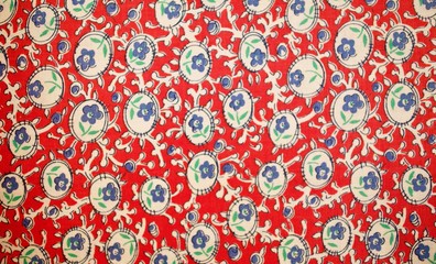 Fragment of colorful retro tapestry text. Fabric striped, flowered texture.