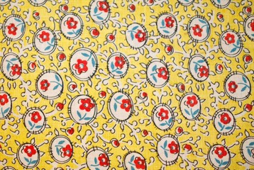 Fragment of colorful retro tapestry text. Fabric striped, flowered texture.