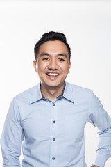 Asian man in work attire looking very happy