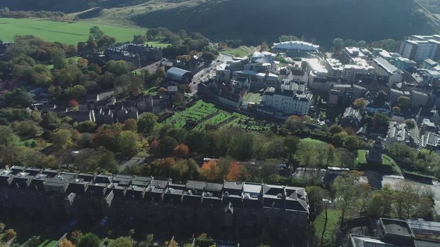 Aerial footage above Calton Hill. Flying left with view to Holyrood Palace and the Scottish Parliament.