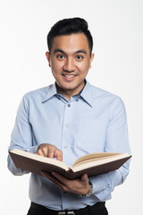 Asian man reading book looking for answer