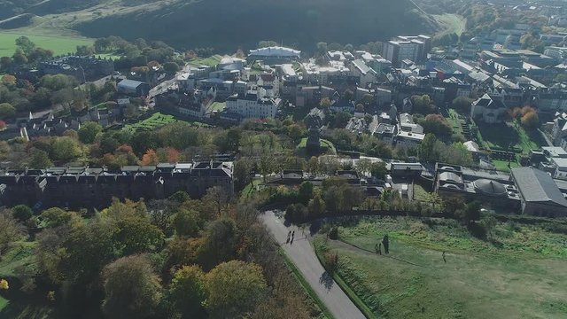 Aerial footage above Calton Hill. Approaching Holyrood Palace and the Scottish Parliament building. 