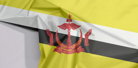 Brunei Darussalam fabric flag crepe and crease with white space, red crest on yellow field cut by black and white diagonal stripes.