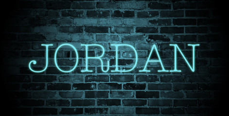first name Jordan in blue neon on brick wall