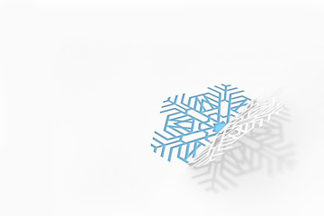 New year's eve greeting card concept. Snowflake cut from paper, casting a shadow. 3d illustration