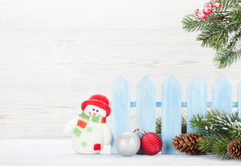 Christmas snowman toy, decor and fir tree branch