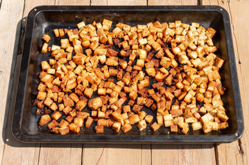 square bread crumbs of dry bread on iron utensils for an oven