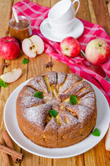 Delicious apple pie with cinnamon and caramel sauce. Traditional cake Charlotte.
