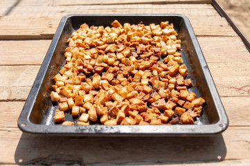 square bread crumbs of dry bread on iron utensils for an oven