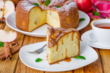 Delicious apple pie with cinnamon and caramel sauce. Traditional cake Charlotte.