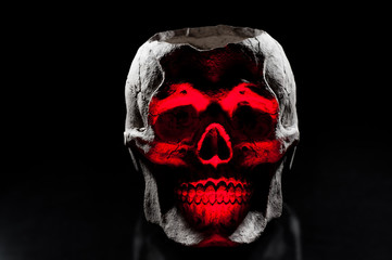 Ceramic skulls on black background. Halloween decor.