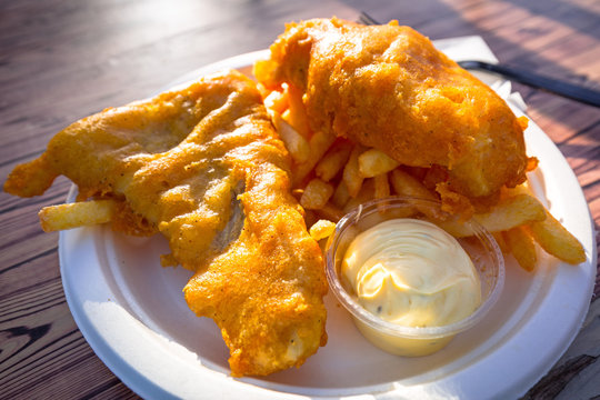 Fried battered fish with chips on a plate