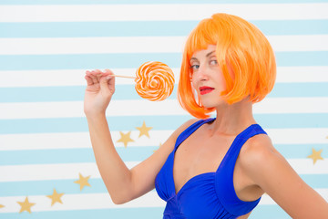 happy pinup model with lollipop. Fashion girl with orange hair have fun. Cool girl with lollipop....