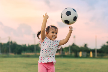 Obraz premium kids are playing soccer football for exercise under the sunlight. Film picture style..
