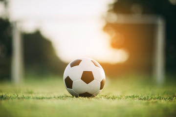 A ball for street soccer football under the sunset ray light. Film picture style.