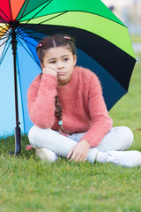 Ways brighten your fall mood. Colorful accessory for cheerful mood. Girl child long hair sad because of fall weather. Stay positive fall season. Little girl sad about fall while sit under umbrella