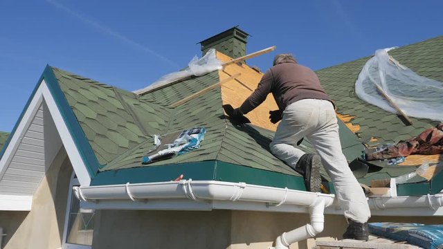 soft roof of shingles. Repair of the roof of a residential house. installation of soft tiles. partial replacement of the damaged roof. Dot repair. Nailing roofing material to the surface of the