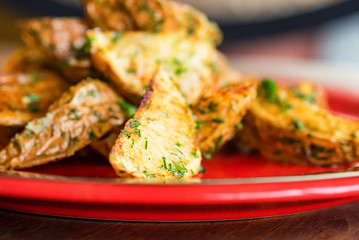 Baked potato wedges with dill and spices close