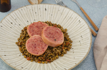 Italian cotechino with lentils on christmas table