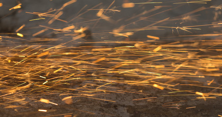 Bright blue and yellow sparks on a black background. Magical lig