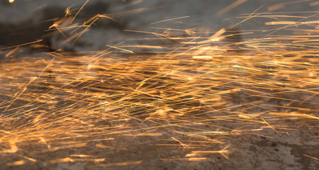 Bright blue and yellow sparks on a black background. Magical lig