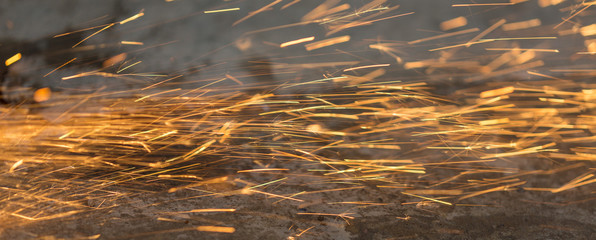 Bright blue and yellow sparks on a black background. Magical lig