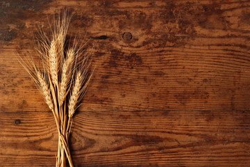 Ears of wheat on wooden background