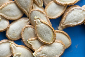 Pumpkin seeds on blue background