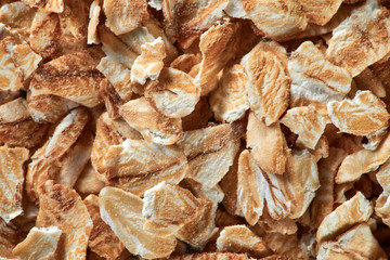 Close-up of raw oatmeal as a background. Oat cereal for dieting food, ingredients for healthy eating. Top view.