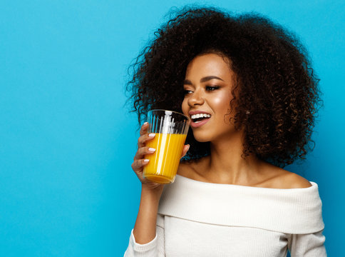 Beautiful African American Girl With Copy Space Drinking A Orange Juice