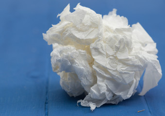 Crumpled paper on blue background