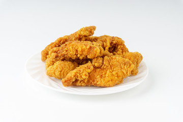 Fried breaded chicken fillet isolated on white background with selective focus and crop fragment
