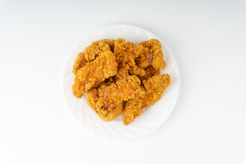 Fried breaded chicken fillet isolated on white background with selective focus and crop fragment