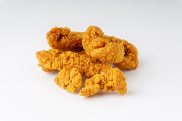 Fried breaded chicken fillet isolated on white background with selective focus and crop fragment