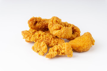 Fried breaded chicken fillet isolated on white background with selective focus and crop fragment