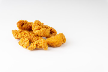 Fried breaded chicken fillet isolated on white background with selective focus and crop fragment