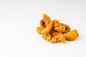 Fried breaded chicken fillet isolated on white background with selective focus and crop fragment