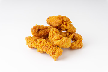Fried breaded chicken fillet isolated on white background with selective focus and crop fragment