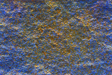 Old scratched blue and gold blur plastered house wall