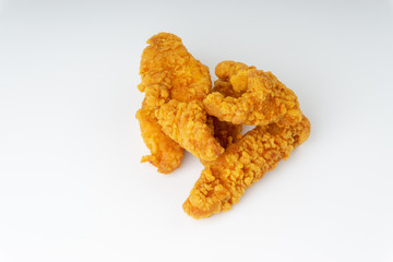 Fried breaded chicken fillet isolated on white background with selective focus and crop fragment