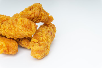 Fried breaded chicken fillet isolated on white background with selective focus and crop fragment