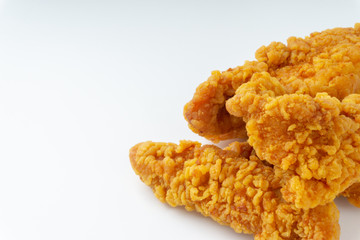 Fried breaded chicken fillet isolated on white background with selective focus and crop fragment