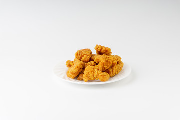 Fried breaded chicken fillet isolated on white background with selective focus and crop fragment