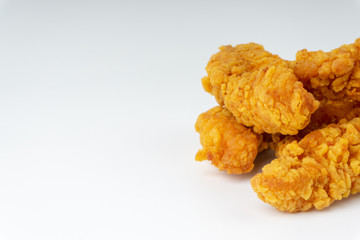 Fried breaded chicken fillet isolated on white background with selective focus and crop fragment