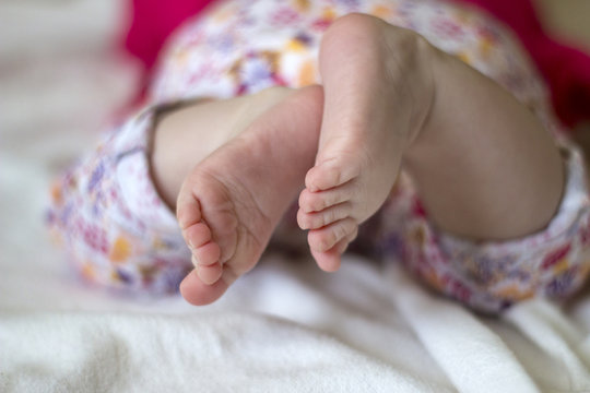 Closeup of small feet of little baby girl 