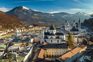Postcard view on Salzburg city with Cathedral and Kollegienkirche church, Austria in winter