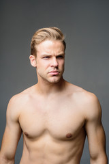 Fototapeta premium Attractive and seductive sensual look. Muscular sexy man. Handsome man with athletic body shirtless. Male beauty, cosmetics. Confident muscular guy. Strong healthy athletic fitness model. Bodybuilder.