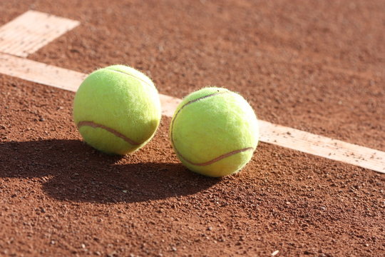 Tennis balls on the court.